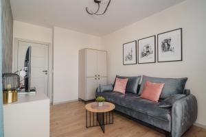 a living room with a couch and a table at TOTU HOME Perspektywa Apartament Gdańsk Centrum in Gdańsk