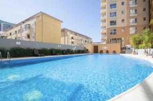 a large swimming pool in the middle of a building at West One Studio Apartments in Gibraltar