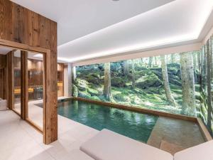 a pool in a house with a large window at Chalet Courchevel, 6 pièces, 10 personnes - FR-1-568-27 in Courchevel