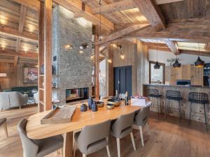 a kitchen and dining room with a wooden table and chairs at Chalet Courchevel, 6 pièces, 10 personnes - FR-1-568-27 in Courchevel