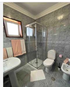 a bathroom with a shower and a toilet and a sink at Estalagem Bela Vista in Mondim de Basto