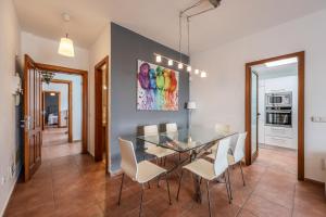 馬西尼古蒂的住宿－VILLAS LANZAROTE LOS ALTOS by NEW LANZASUITES Villa SERENA，一间设有玻璃桌和白色椅子的用餐室