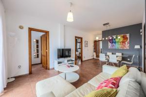 a living room with a couch and a table at VILLAS LANZAROTE LOS ALTOS by NEW LANZASUITES Villa SERENA in Playa Blanca