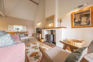 a living room with a couch and a fire place at Water Mill House in Burnham Market