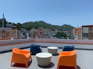 four chairs and tables on top of a roof at Ogeri76 in Mokpo