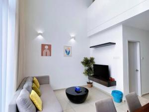 a living room with a couch and a tv at Duplex 4PX Free Parking @ ICITY, Near SOGO & ThemePark in Shah Alam
