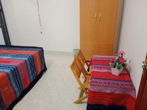 a room with two tables and a chair with flowers at Ha Giang Yolo House and Loop Tours in Ha Giang