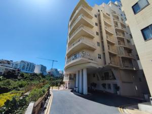 a building on the side of a road at St Julians - Balluta 2 bedroom apartment in St Julian's