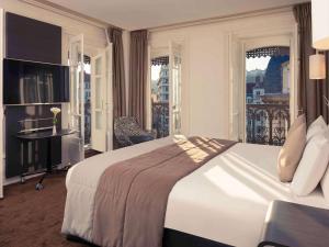 a hotel room with a large bed and a balcony at Mercure Lyon Centre Beaux-Arts in Lyon +37 photos