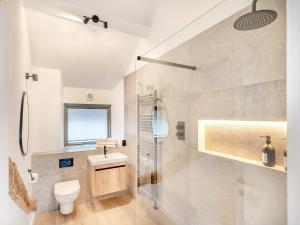 a bathroom with a toilet and a sink and a shower at Beach Haven in Arnside
