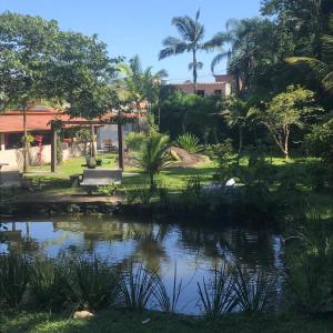 a view of a pond in a park at Recanto do Zeca in Praia Grande