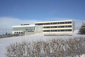 a building with a parking lot in front of it at Hotel Höfn in Höfn