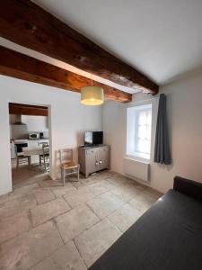 a living room with a bed and a table at "Le N3" Beaucaire centre-ville in Beaucaire