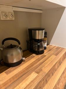 a food processor and a pot on a wooden floor at Appartement au pied de la grand place in Brussels