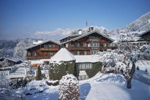 a large building covered in snow in front at Relais & Châteaux Hotel Tennerhof in Kitzbühel