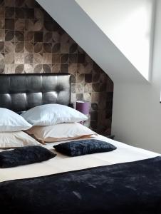 a bed with two pillows on it in a room at Sweetnest by home in Waterloo