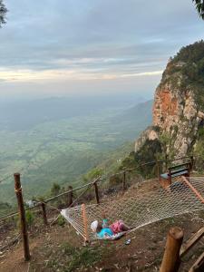 a person laying on a hammock on a mountain at Uvi House & Restaurant 