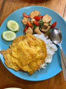 a blue plate of food with rice and vegetables at kohkoodfarmstay in Ban Ao Yai