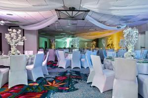 a banquet hall with white chairs and tables at Embassy Suites by Hilton Los Angeles International Airport South in El Segundo +37 photos