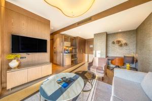 a living room with a couch and a table at Radisson Collection Hotel, Vadistanbul in Istanbul