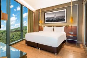 a bedroom with a large bed and large windows at Radisson Collection Hotel, Vadistanbul in Istanbul