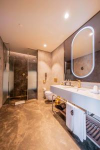 a bathroom with a sink and a shower at Radisson Collection Hotel, Vadistanbul in Istanbul