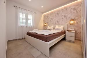 Postel nebo postele na pokoji v ubytování Apartments Jasmina