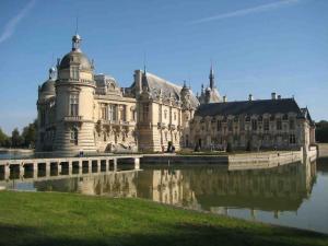 a large building next to a body of water at La crème de la crème - Chantilly in Chantilly +2 photos