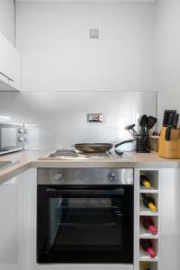 a kitchen with a stove top oven in a kitchen at Studio Apartment in Central Maidstone in Kent