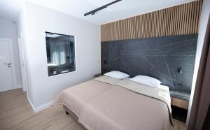 a bedroom with a bed with a black wall at A Heritage Split in Split