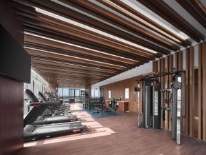 a gym with lots of treadmills and machines at Hilton Garden Inn Nantong Rudong in Nantong