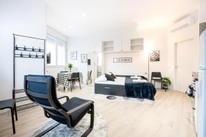 a bedroom with a bed and a chair at All in One Parma in Parma +8 photos
