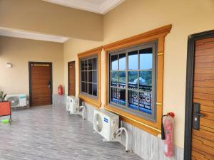 a room with windows and a balcony with a view at C-VISION GUESTHOUSE 