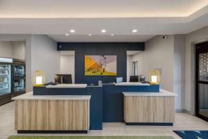 a lobby with two reception desks in a building at Spark by Hilton Midland South in Midland