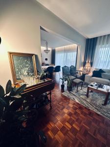 a living room with a grand piano and a living room at Beautiful ocean view home in Paço de Arcos