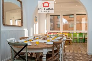 a dining room with a table with chairs and a mirror at Ca la Murada in Palamós