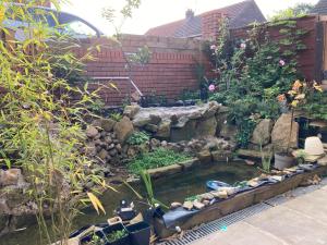 a garden with a small pond in a yard at Jacks Court B3 in Ashton under Lyne