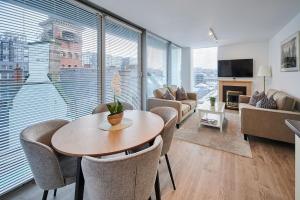 uma sala de estar com mesa e cadeiras em Host & Stay - The Municipal View Abode em Liverpool