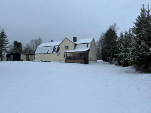 una casa con nieve en el suelo en un patio en Teenuse loft, 