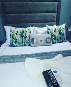 a bed with two remote controls sitting on top of it at President Guest Lodge in Louis Trichardt