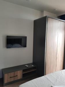 a bedroom with a bed and a wooden cabinet at Euro Palace Gonio in Gonio +8 photos