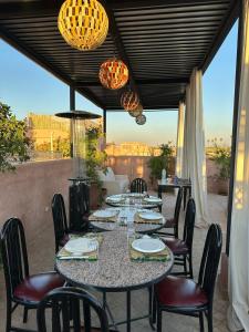 a patio with a table and chairs and lights at Riad Atrium & Spa in Marrakesh