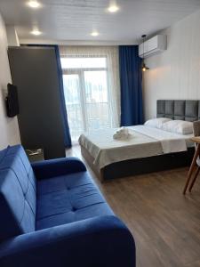 a hotel room with a bed and a couch at Euro Palace Gonio in Gonio