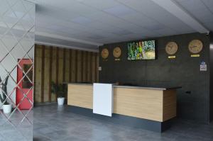 a lobby with a counter and clocks on the wall at Euro Palace Gonio in Gonio +15 photos