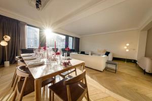 a dining room with a table and a living room at City Luxury: 3BR, Prime Location in Brussels