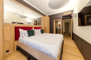 a bedroom with a large bed with a red headboard at City Luxury: 3BR, Prime Location in Brussels