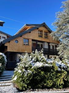 a house with snow covered bushes in front of it at Chalet Yuki in Morzine