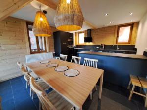 a dining room with a wooden table and chairs at Chalet Yuki in Morzine