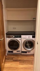 a laundry room with a washer and dryer at Bayview Cottage in Lamlash