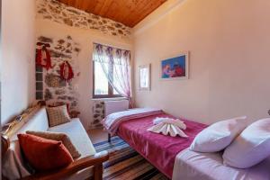 a bedroom with two beds and a window at Petrino House Lasithi in Agios Georgios